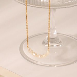 Close-up of five freshwater baroque pearls on a 18K gold plated stainless steel chain