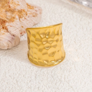 Chunky 18k gold plated stainless steel ring with hammered water ripple texture on white background