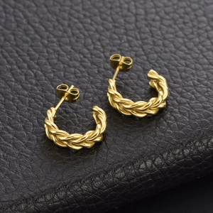 High-quality chunky gold braided twist earrings made of titanium steel on black leather