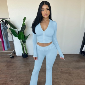 Detail of light blue slim fit tracksuit with zip hoodie and high waist flare pants