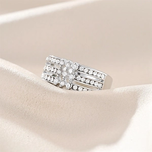 Macro shot of silver wide band ring with multi-layered cubic zirconia micro-pave setting