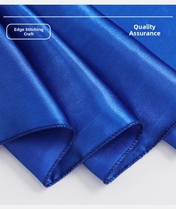 Close-up of royal blue satin chair sash showing high-quality overlock stitching detail
