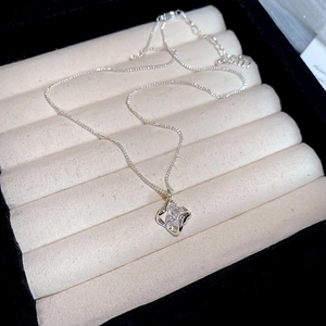 Macro shot of silver square cubic zirconia pendant in luxury velvet jewelry box