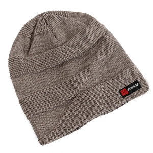 Detail of dark brown knitted beanie showing thick ribbed texture and fashion patch