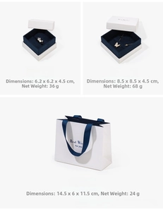 Detailed view of white jewelry gift box set with navy velvet lining and gold Best Wishes text