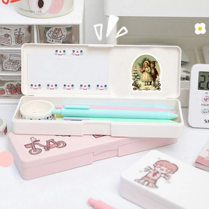 Detail view of pink and white plastic stationery box with creative stickers and pen storage