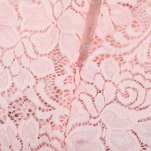Detail of pink lace fabric with matching invisible zipper on a long sleeve bodysuit