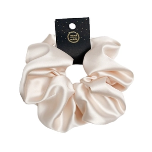 Elegant 18cm oversized beige satin scrunchie with handmade tag on white background