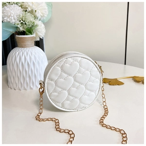 Detailed view of white heart-quilted round mini bag with gold chain and floral decor