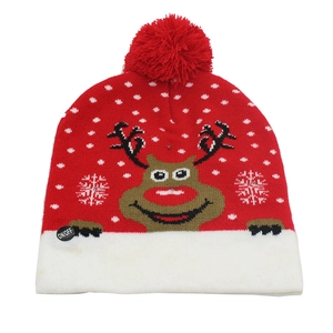 Close-up of the red LED Christmas hat showing the power switch and reindeer knit pattern
