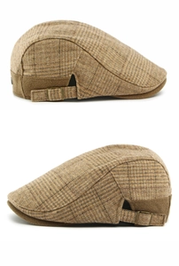 Detail view of brown plaid wool newsboy caps with vintage adjustable metal buckles