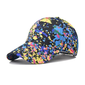 Close-up of vibrant splatter paint patterns on a black cotton baseball cap detail