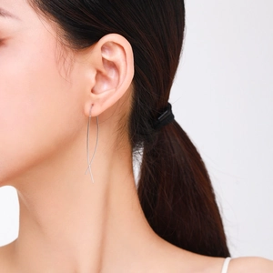 Minimalist S925 sterling silver drop line earrings worn by model on white background