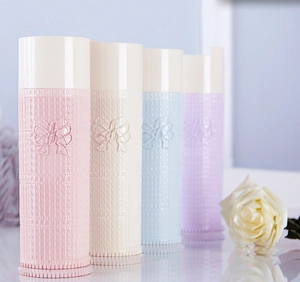 Detail of four pastel toothbrush cases featuring elegant bow reliefs and woven textures