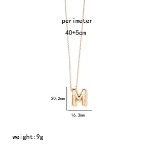 Detail view of gold letter M pendant with dimensions and specifications on white background