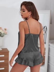 Close-up of dark grey satin silk pajamas set showing the sleek back cut and ruffled shorts