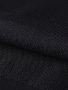 Detailed macro view of black breathable mesh knit fabric texture for t-shirt detail