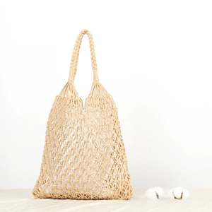 Detail of handmade cotton rope mesh bag with hollow geometric pattern and inner lining