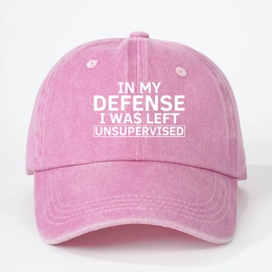 Close-up of pink washed denim baseball cap with In My Defense I Was Left Unsupervised text