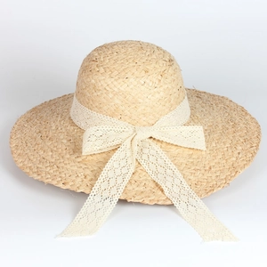 Wide brim raffia sun hat with white lace ribbon bow for summer beach vacation