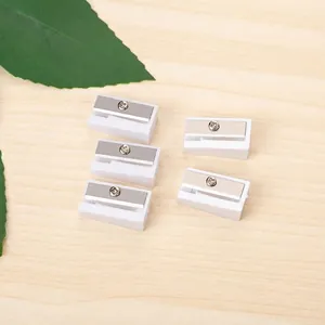 Detailed set of five stainless steel replacement blades for pencil sharpeners on wood