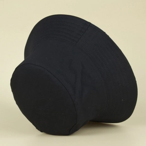 Detail view of the black cotton bucket hat showing reinforced stitching on the brim