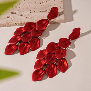 Detailed view of red acrylic flower petal tassel earrings with elegant matte finish