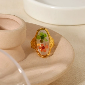 Macro shot of 18K gold plated ring featuring resin floral inlay with real dried flowers