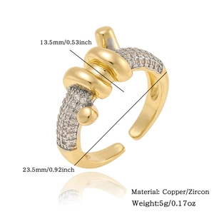 Detail view of gold flower knot ring with zircon inlay and product dimensions shown