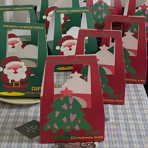 Christmas gift boxes with Santa illustrations and clear window on a checkered cloth