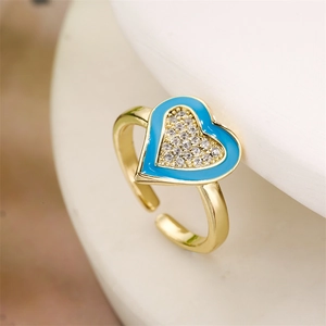 Detail of heart ring with blue enamel and micro-set cubic zirconia on gold band