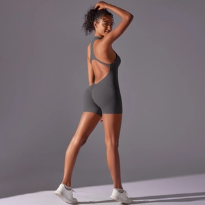 Detail of cross-back yoga bodysuit in dark grey with high-stretch athletic fabric