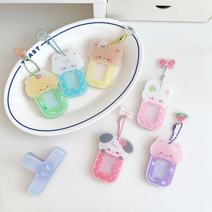 Cartoon animal photo frame keychains in pastel colors with beaded chains on a white plate
