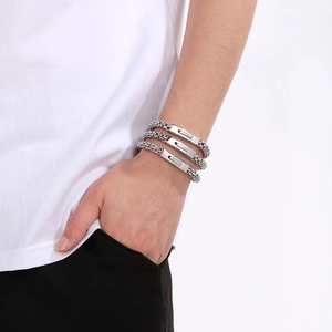 Close-up of three-piece silver titanium steel woven bracelets with polished metal buckles