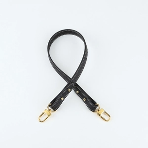 Close-up of black lychee grain leather shoulder strap with gold swivel metal hooks