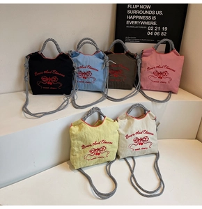 Close-up of candy-colored nylon tote bags with embroidery in six vibrant color options
