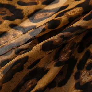 Close-up of leopard print sheer fabric with soft texture and translucent finish