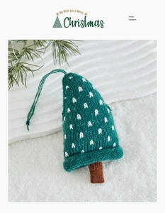 Close-up of green knitted Christmas tree ornament with festive snow-like background