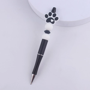 Detailed view of DIY beadable pen featuring a cute black paw print with white heart detail