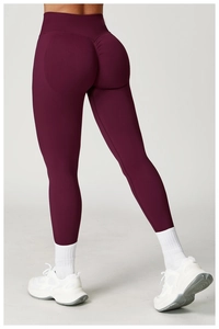 Macro shot of seamless scrunch-butt leggings featuring deep burgundy high waist fabric