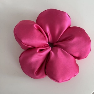 Macro shot of rose red satin flower hair scrunchie with five glossy 3D silk petals