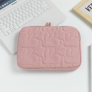 Pink minimalist laptop sleeve with quilted rabbit patterns and metal zipper closure