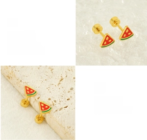 Detail of watermelon stud earrings in gold-tone steel with red and green enamel coating