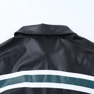 Detail of vintage black faux leather jacket with green and white striped back stitching