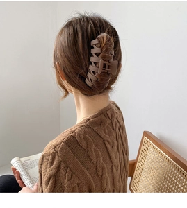 Detailed back view of a large matte brown shark hair claw clip in a stylish updo hairstyle