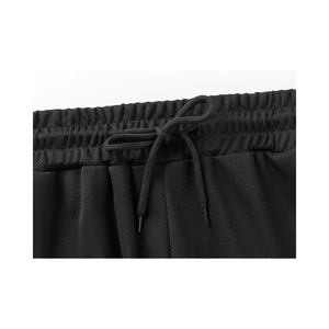 Close-up of elastic waistband with adjustable drawstring and breathable mesh fabric