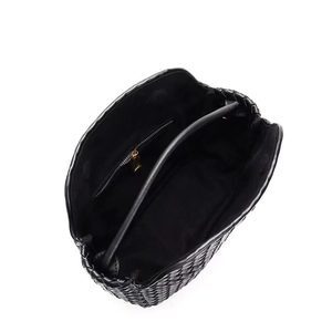 Top view of black woven leather handbag interior showing a secure gold zipper pocket