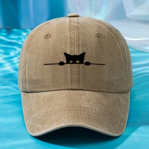 Close-up of a black cat embroidery on a khaki washed cotton baseball cap with blue waves