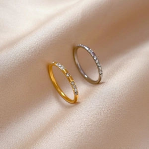Minimalist titanium steel rings in gold and silver with cubic zirconia on silk