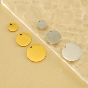 Macro detail of round gold and silver stainless steel pendants in multiple sizes